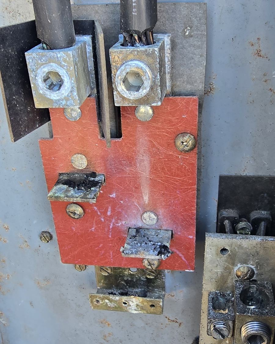 A burnt meter base on the outside of a house