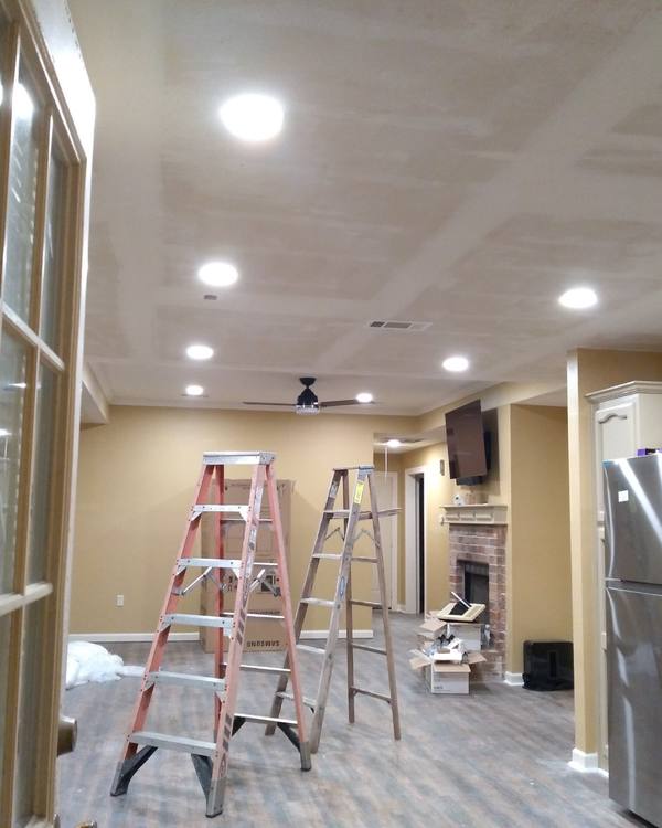 A ceiling fan and new recessed lights in a finished room