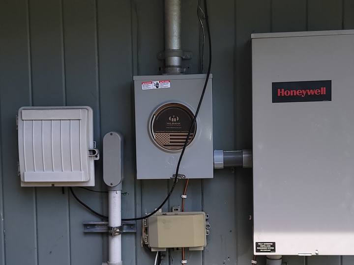 Our photo: a meter and panel on siding