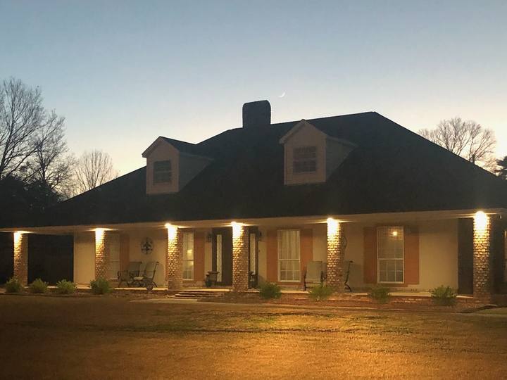 Our photo: a house at dusk with its lights on