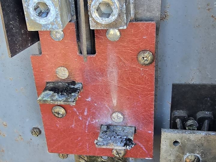 A burnt meter base on the outside of a house