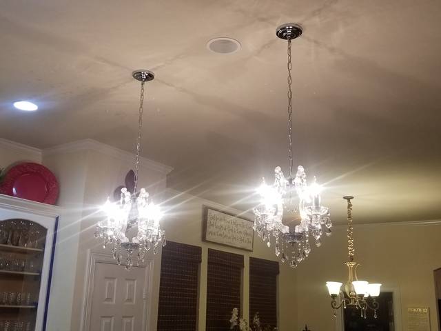 Chandeliers and pendant lights hung in a large room