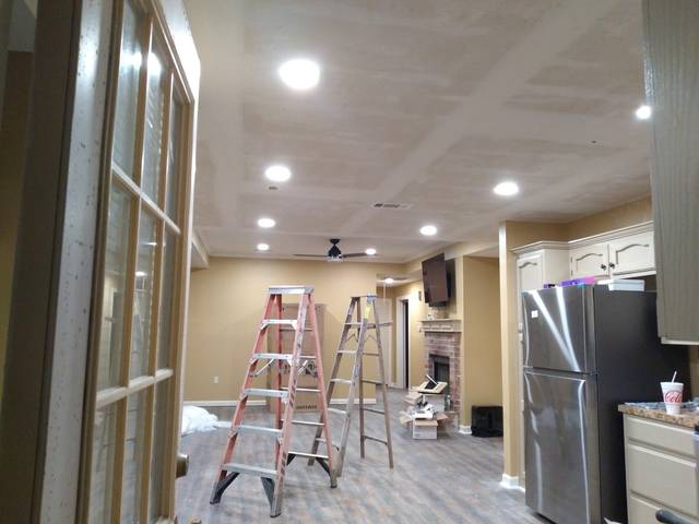 New recessed lights and a ceiling fan in a remodeled room