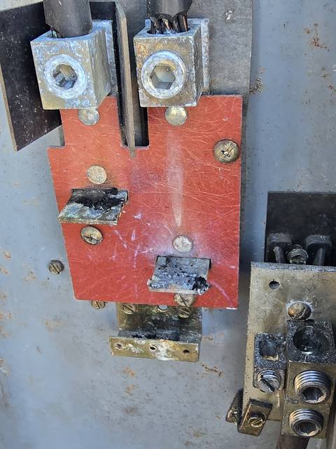 A burnt meter base on the outside of a house